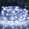A coiled string of white LED lights with a reflective surface below. Produktbild-Vorschau