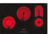A top-down view of a black ceramic glass electric cooktop with four heating elements, three of which are glowing red with heat. Produktbild-Vorschau