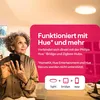 A woman is holding a smartphone and looking up at a ceiling light. A pink overlay contains marketing text and icons. Produktbild-Vorschau