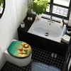 A bathroom scene featuring a toilet with a decorative seat, a sink, and a window. Produktbild-Vorschau