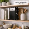 A kitchen shelf displaying a multi-functional maker, books, and kitchenware. Produktbild-Vorschau