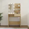 A makeup vanity with LED lights and shelves, set against a plain wall. Voir les images du produit