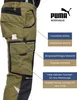 A person wearing green work pants with black accents, with callouts highlighting features. Produktbild-Vorschau