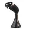 A product shot of a black garment steamer with gold accents on a white background. Podgląd zdjęcia produktu