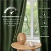 A green velvet curtain is shown next to a window, with a table and a lamp in the foreground. Text overlays describe the product's features. Voir les images du produit