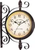 A double-sided antique-style station clock mounted on a decorative wrought iron bracket. Produktbild-Vorschau