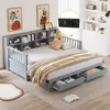 A daybed with storage drawers and a bookshelf headboard, set up in a bedroom with artwork on the wall and a bookshelf in the background. Náhled obrázku produktu