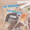 Various food items sealed in vacuum bags on a wooden surface. Podgląd zdjęcia produktu