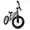 A green balance bike with black wheels and handlebars, shown from a low angle against a white background. Produktbild-Vorschau