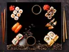 A flat lay of sushi and coffee beans on a dark background. Náhľad obrázku produktu