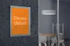 A "Do not disturb" sign is mounted on a dark textured wall next to a glass-enclosed room with a table and chairs. Náhľad obrázku produktu