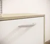 A close-up view of a white cabinet with a wooden top and a silver handle. Produktbild-Vorschau