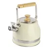A cream-colored whistling kettle with a wooden handle and lid knob, set against a white background. Náhled obrázku produktu
