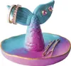 A mermaid tail shaped jewelry holder with rings and bobby pins. Produktbild-Vorschau