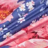 A close-up view of a floral patterned fabric, likely bedding, showing the texture and design. Náhled obrázku produktu