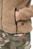 A close-up of a person wearing a beige teddy fleece jacket and camouflage pants. Produktbild-Vorschau