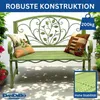 A green metal garden bench with decorative scrollwork and two cushions, placed outdoors on a patio with dappled sunlight. Podgląd zdjęcia produktu