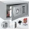 A safe with its door open, showing the interior and the electronic keypad. Accessories like batteries, keys, and mounting bolts are displayed in the foreground. Produktbild-Vorschau