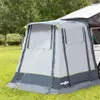 A tent attached to the side of a white van, set up on a grassy area with trees in the background. Produktbild-Vorschau