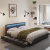 A bedroom scene featuring a bed with LED lighting and storage drawers. Anteprima dell’immagine prodotto