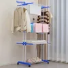 A multi-tiered drying rack with clothes and towels on it, placed indoors near a window with curtains. Produktbild-Vorschau