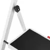 Close-up view of a white folding step stool with a black textured step. Produktbild-Vorschau