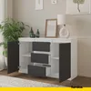 A modern sideboard with drawers and doors, set in a well-lit room with a plant and artwork. Náhľad obrázku produktu