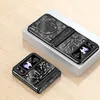 Two black flip phones with intricate designs, one open and one closed, displayed on a white platform against a light wooden background. Produktbild-Vorschau
