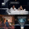 Collage of four scenes showing different uses of a projector: bedtime relaxation, outdoor movie, and home theater. Voir les images du produit