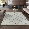 A modern living room with a fireplace, sofa, and a shaggy rug with a diamond pattern. Produktbild-Vorschau