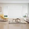A living room scene with a yellow armchair, a coffee table with books, and a large window with white blinds. Produktbild-Vorschau
