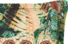 A close-up view of a fabric with a jungle print. Produktbild-Vorschau