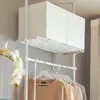 A white telescopic clothes rack with two fabric storage boxes on top and clothes hanging below. Produktbild-Vorschau