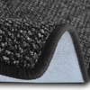 A close-up view of a dark gray carpet with a black edge binding, showing the texture and underside. Produktbild-Vorschau