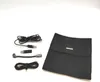 A black carrying pouch and various black cables and adapters are laid out on a white background. Produktbild-Vorschau