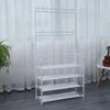 A white metal garment rack with four shelves for shoes, placed indoors in front of a window with sheer curtains. Anteprima dell’immagine prodotto