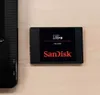 A SanDisk Ultra 3D SSD is shown next to a black electronic device. Náhľad obrázku produktu