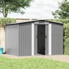 A grey metal garden shed is shown in a backyard setting with grass and a wooden deck. Náhled obrázku produktu