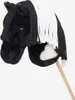 A close-up studio shot of a black and white hobby horse on a stick. Produktbild-Vorschau