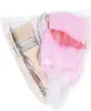 A clear plastic bag containing several items, including paintbrushes and pink fluffy objects. Produktbild-Vorschau