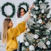 A mother and daughter decorating a Christmas tree. Anteprima dell’immagine prodotto