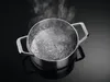 A close-up shot of a pot of boiling water on a black surface. Anteprima dell’immagine prodotto