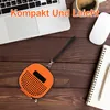A flat lay of a laptop, coffee cup, mouse, notebook, pen, and an orange accessory case on a wooden table. Produktbild-Vorschau