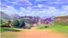 A picturesque village scene with rolling hills, houses, and a blue sky with clouds. Produktbild-Vorschau