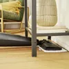 A steam mop head is shown on a white pad under a shelf unit in a room with a chair and decorative vase. Produktbild-Vorschau