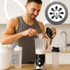 A man is preparing a protein shake in a kitchen. Produktbild-Vorschau