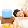 A woman receiving a massage with an aroma diffuser in the foreground. Anteprima dell’immagine prodotto