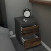 A bedside table with two drawers and a vintage alarm clock on top. Voir les images du produit