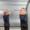 Two workers installing a garage door. Produktbild-Vorschau
