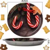 A round metal plate with a Christmas-themed design of candy canes, gingerbread cookies, and pine branches, shown from a top-down perspective. Below the plate, a side view of the metal plate is shown, indicating its depth. Several gingerbread cookies and st Produktbild-Vorschau